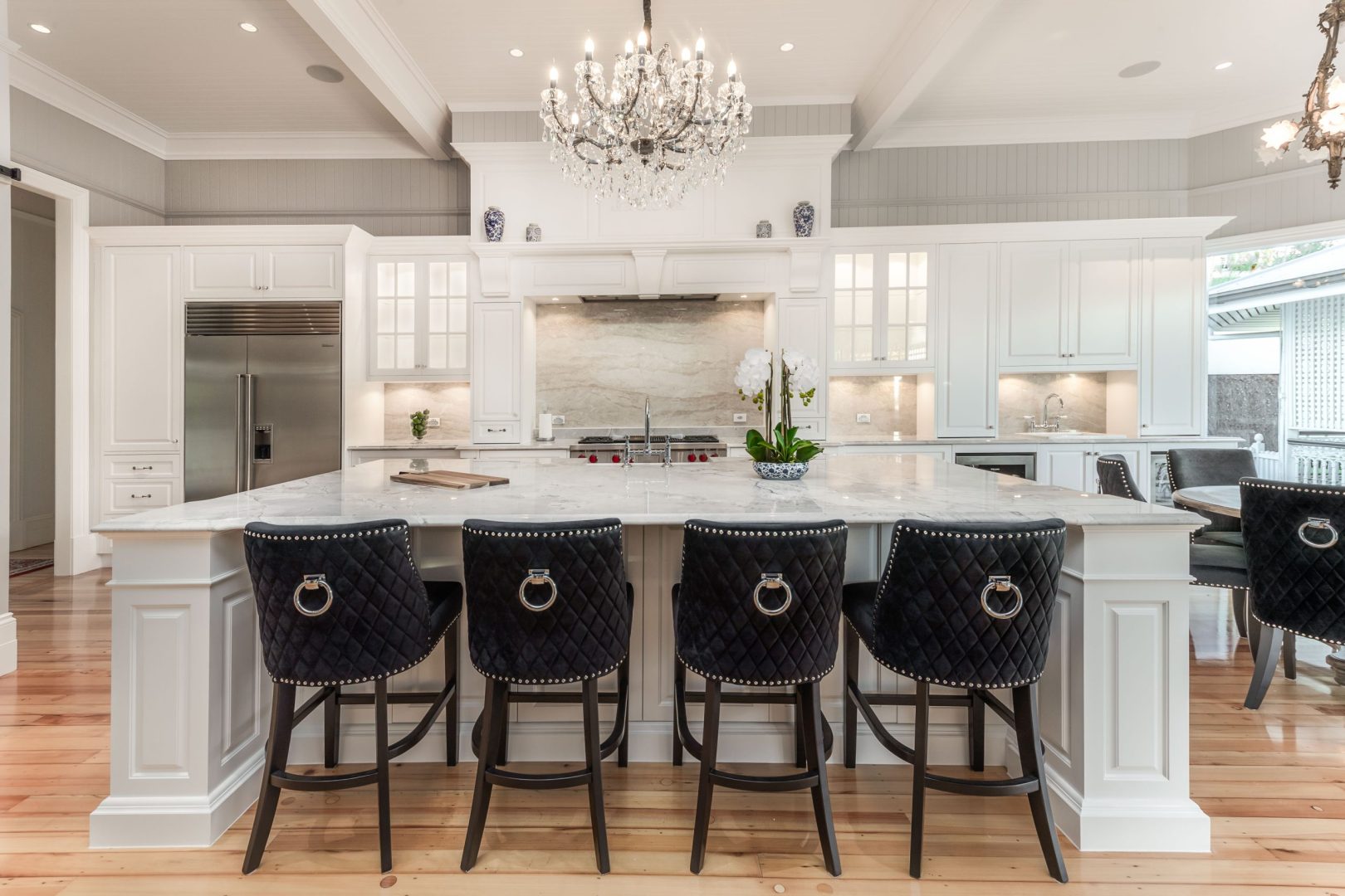 Custom Cabinetry Gallery in Brisbane | Brisbane Kitchen Design Trends for 2025 | Dana Kitchens | Traditional Hampton style kitchen with natural stone and glass feature doors