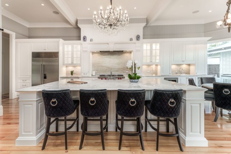 Custom Cabinetry Gallery in Brisbane | Brisbane Kitchen Design Trends for 2025 | Dana Kitchens | Traditional Hampton style kitchen with natural stone and glass feature doors