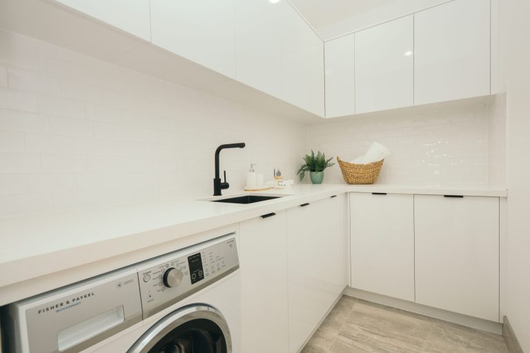 Custom Cabinetry Gallery in Brisbane | Brisbane Kitchen Design Trends for 2025 | Dana Kitchens | Modern white laundry / scullery area with black details